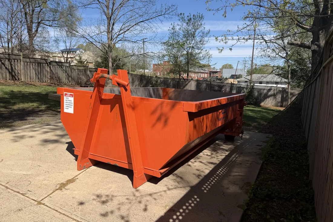 Waste On Wheels low-wall dumpster, the style used for concrete and masonry loads