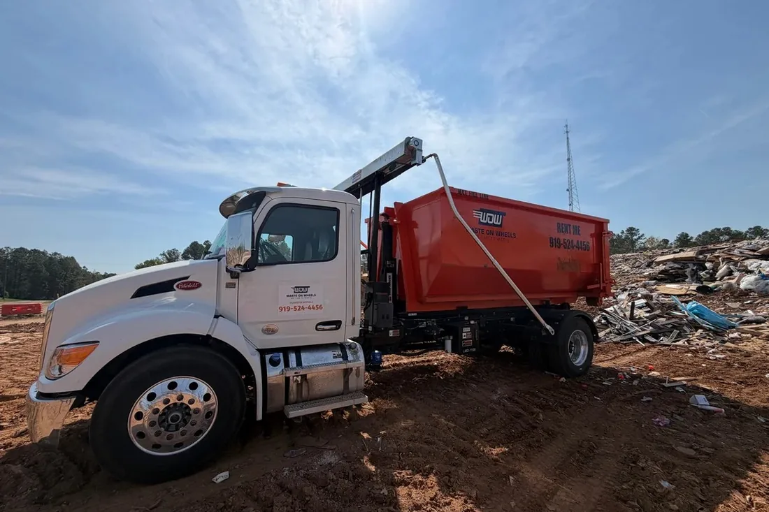 Waste On Wheels roll-off dumpster loaded with construction debris near Clayton, NC