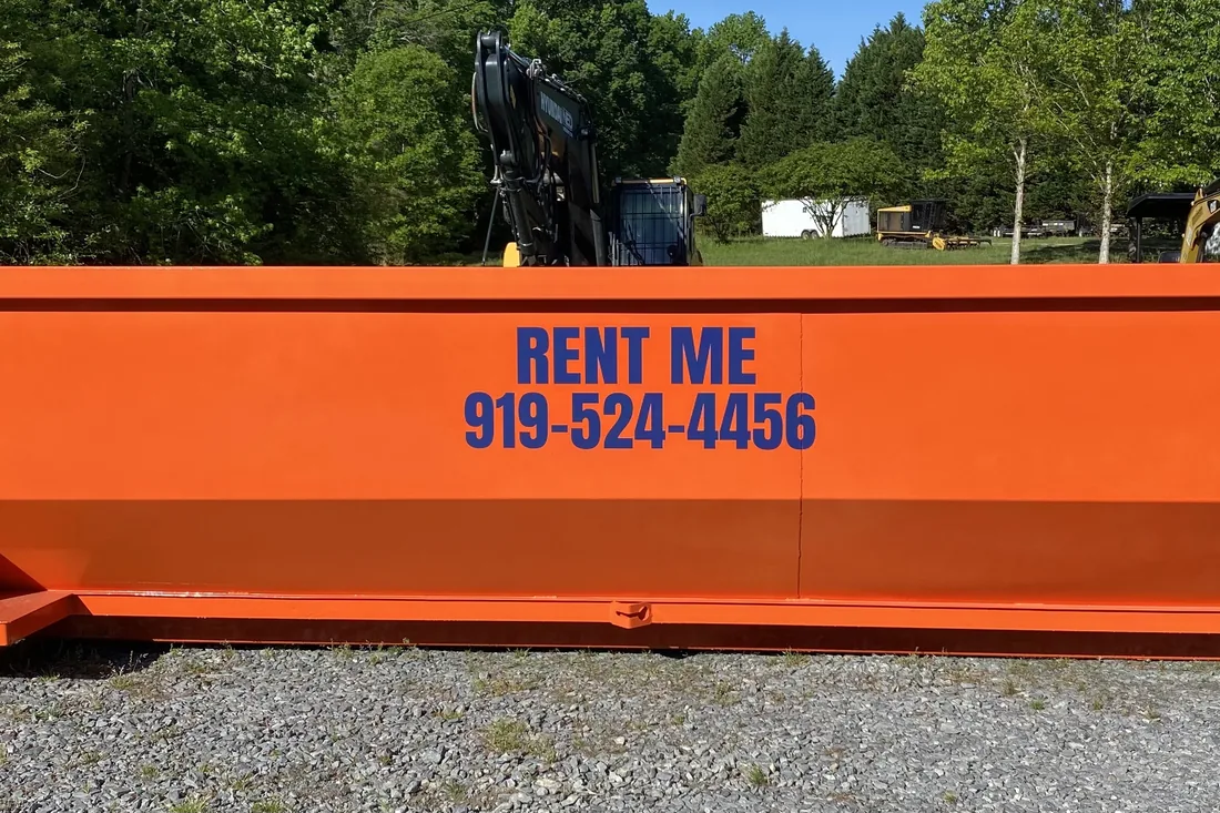 Waste On Wheels dumpster loaded with brush and yard debris in Willow Spring, NC